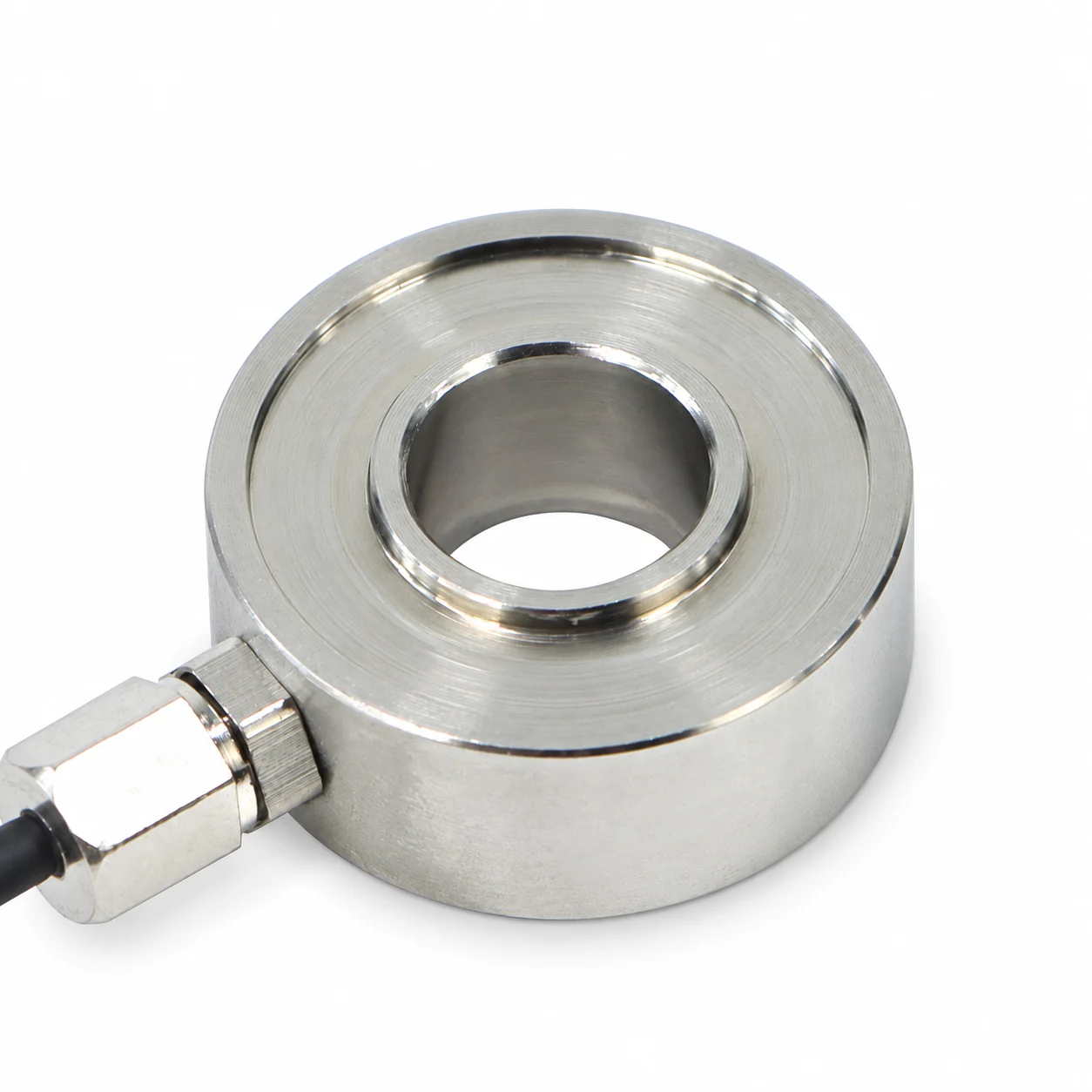 Machined silver donut load cell with an open center bore, narrow inner loading rim and lower-left cable gland